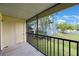 Screened in balcony with wooden deck overlooks lawn and neighborhood at 413 Somerset Ln, Palm Harbor, FL 34684