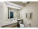 Bright bathroom featuring a neutral vanity, mirror and tile flooring at 413 Somerset Ln, Palm Harbor, FL 34684