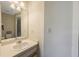 Bright bathroom featuring a neutral vanity, mirror and tile flooring at 413 Somerset Ln, Palm Harbor, FL 34684