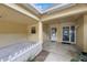 The entryway features a small fence and glass doors creating an inviting atmosphere at 413 Somerset Ln, Palm Harbor, FL 34684