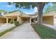 Townhouse featuring convenient covered parking and lush greenery, creating an inviting exterior at 413 Somerset Ln, Palm Harbor, FL 34684