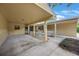 Welcoming townhouse facade, highlighting a covered driveway and charming landscaping at 413 Somerset Ln, Palm Harbor, FL 34684