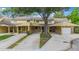 Inviting townhouse complex with covered parking and mature landscaping for a welcoming neighborhood feel at 413 Somerset Ln, Palm Harbor, FL 34684
