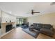 Spacious living room featuring a stone fireplace, sliding glass doors to the porch, and a comfortable seating area at 413 Somerset Ln, Palm Harbor, FL 34684