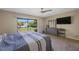 Bright main bedroom with ceiling fan, sliding glass doors, and neutral decor for a comfortable retreat at 413 Somerset Ln, Palm Harbor, FL 34684