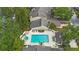 Aerial view of community pool and surrounding buildings at 413 Somerset Ln, Palm Harbor, FL 34684