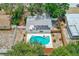 Aerial view of house featuring solar panels, a fenced yard, and a backyard with a kidney-shaped pool at 4228 Tarpon Se Dr, St Petersburg, FL 33705