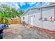 Backyard features a utility door, AC unit and partial view of wooden fence at 4228 Tarpon Se Dr, St Petersburg, FL 33705