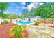 Inviting backyard pool surrounded by lush tropical landscaping and a privacy fence, perfect for relaxing and entertaining at 4228 Tarpon Se Dr, St Petersburg, FL 33705