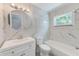 Bathroom features marbled tile walls, tile flooring, a bathtub, and a modern vanity at 4228 Tarpon Se Dr, St Petersburg, FL 33705