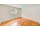 Cozy bedroom has hardwood floors, neutral walls, and window letting in natural light at 4228 Tarpon Se Dr, St Petersburg, FL 33705