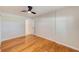 Bright bedroom features wood flooring, light walls, ceiling fan and a doorway to another room at 4228 Tarpon Se Dr, St Petersburg, FL 33705