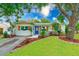 Charming home featuring a well-manicured lawn and beautifully landscaped garden beds at 4228 Tarpon Se Dr, St Petersburg, FL 33705