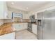 Modern kitchen with white cabinets, stainless steel appliances, wood countertops, and tile floors at 4228 Tarpon Se Dr, St Petersburg, FL 33705