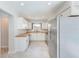 Modern kitchen with white cabinets, stainless steel appliances, wood countertops, and tile floors at 4228 Tarpon Se Dr, St Petersburg, FL 33705