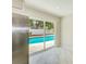 View from inside towards the pool and backyard, featuring a stainless steel refrigerator at 4228 Tarpon Se Dr, St Petersburg, FL 33705
