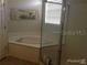 Bright bathroom featuring a garden tub, and separate glass-enclosed shower stall at 4512 River Overlook Dr, Valrico, FL 33596