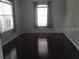 A bright and airy bedroom with hardwood floors and natural light streaming through the windows at 4512 River Overlook Dr, Valrico, FL 33596