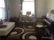 Cozy bedroom with neutral tones, large windows, a patterned rug, and piano at 4512 River Overlook Dr, Valrico, FL 33596