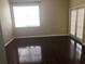 Bright and airy bedroom with polished wood floors and a sliding glass door to the outside at 4512 River Overlook Dr, Valrico, FL 33596