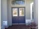 Close up showing charming blue double door entry with glass panes and transom window allowing natural light at 4512 River Overlook Dr, Valrico, FL 33596