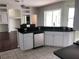 Spacious kitchen with a breakfast bar overlooking living area, stainless steel appliances, and ample countertop space at 4512 River Overlook Dr, Valrico, FL 33596