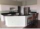 Bright kitchen featuring white cabinetry, stainless steel appliances, a breakfast bar, and tile floors at 4512 River Overlook Dr, Valrico, FL 33596