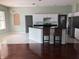 Bright open kitchen featuring stainless steel appliances, a breakfast bar and tile and hardwood floors at 4512 River Overlook Dr, Valrico, FL 33596