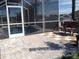 Private screened-in lanai with paver patio surrounds a sparkling pool with spa and waterfall features at 4512 River Overlook Dr, Valrico, FL 33596