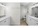Bathroom featuring double sinks, modern fixtures, and a separate toilet area at 4705 W Estrella St, Tampa, FL 33629