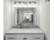 Well-lit bathroom featuring a marble countertop vanity with modern fixtures and a large mirror at 4705 W Estrella St, Tampa, FL 33629