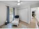 Inviting bedroom space with a comfortable chair, closet and hardwood floors, bathed in natural light at 4705 W Estrella St, Tampa, FL 33629