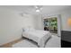 Bright bedroom featuring a queen size bed, a ceiling fan and a sliding glass door to the backyard at 4705 W Estrella St, Tampa, FL 33629