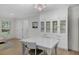 Open dining area with a decorative chandelier and built-in white cabinets at 4705 W Estrella St, Tampa, FL 33629