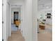 Hallway view leading to a well-lit living area featuring hardwood floors and neutral walls at 4705 W Estrella St, Tampa, FL 33629