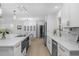 Spacious white kitchen featuring an island, wine fridge, and modern appliances at 4705 W Estrella St, Tampa, FL 33629