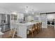 Contemporary kitchen featuring an island with bar stools, stainless appliances, and laundry room access at 4705 W Estrella St, Tampa, FL 33629