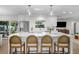Modern kitchen with a large island, stainless steel refrigerator, and pendant lighting at 4705 W Estrella St, Tampa, FL 33629