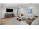 Cozy living room with a comfortable sofa, a media cabinet, and ample natural light at 4705 W Estrella St, Tampa, FL 33629