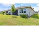 Lush green backyard with healthy vegetation and mature shrubs and trees at 4914 Sienna Isles Ave, Wimauma, FL 33598