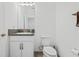 Clean, well-lit bathroom with a white vanity, toilet, and modern fixtures at 4914 Sienna Isles Ave, Wimauma, FL 33598