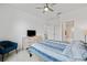 Comfortable bedroom with a blue accent chair, dresser, and serene views from the window at 4914 Sienna Isles Ave, Wimauma, FL 33598