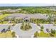 Stunning view of the clubhouse entrance featuring a circular drive, manicured landscaping, and elegant architecture at 4914 Sienna Isles Ave, Wimauma, FL 33598