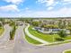 Grand community entrance with lush landscaping, elegant signage, and paved roads at 4914 Sienna Isles Ave, Wimauma, FL 33598