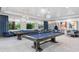 Spacious game room featuring multiple pool tables, comfortable seating, and stylish decor for entertainment at 4914 Sienna Isles Ave, Wimauma, FL 33598