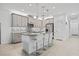 Modern kitchen with gray cabinetry, stainless steel appliances, an island with seating, and pendant lighting at 4914 Sienna Isles Ave, Wimauma, FL 33598