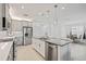 Spacious open-concept kitchen featuring a center island, modern appliances, and a dining area beyond at 4914 Sienna Isles Ave, Wimauma, FL 33598