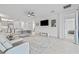 Open concept living room featuring tile floors, modern furnishings, and seamless access to the kitchen area at 4914 Sienna Isles Ave, Wimauma, FL 33598