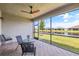 Relaxing screened-in patio with a ceiling fan and views of the lake at 4914 Sienna Isles Ave, Wimauma, FL 33598