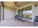 Cozy screened patio with seating and a view of the serene surroundings at 4914 Sienna Isles Ave, Wimauma, FL 33598